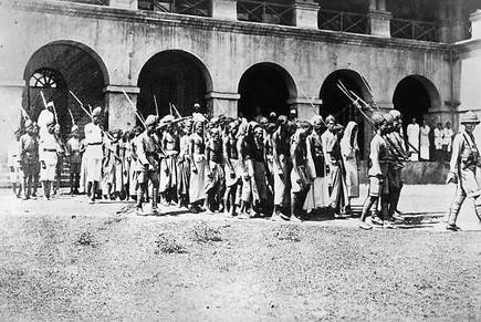 A picture by Topical Press Agency/Getty Images, captioned September 26, 1925: “Moplah prisoners go to trial at Calicut on the Malabar Coast in India’s south-western state of Kerala, charged with agitation against British rule in India.”